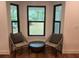 Inviting sitting area with a black frame window, comfortable chairs and natural light at 1245 Nw 73Rd Ter, Ocala, FL 34482