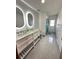 Modern bathroom featuring dual sinks and stylish vanity at 13506 Sw 43Rd Cir, Ocala, FL 34473