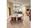 Cozy dining area featuring tile flooring and a chandelier with views into the kitchen and living room at 13506 Sw 43Rd Cir, Ocala, FL 34473