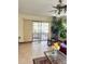 Bright living room with tile flooring and sliding glass doors leading to a screened-in patio at 13506 Sw 43Rd Cir, Ocala, FL 34473