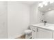 Bathroom featuring white cabinets, granite countertops, tiled walls, and modern fixtures at 14876 Se 34Th Ter, Summerfield, FL 34491