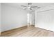 Spacious bedroom with a ceiling fan and beautiful wood laminate flooring at 14876 Se 34Th Ter, Summerfield, FL 34491