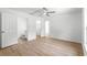 Bright bedroom features hardwood floors, white walls, ceiling fan and two large closets at 14876 Se 34Th Ter, Summerfield, FL 34491