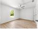 Bedroom featuring hardwood floors, a ceiling fan, a window, and white walls at 14876 Se 34Th Ter, Summerfield, FL 34491