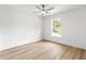 Bright bedroom featuring a ceiling fan, wood laminate flooring, and window views at 14876 Se 34Th Ter, Summerfield, FL 34491