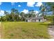 Expansive front yard view of a quaint single-story home under a blue sky at 14876 Se 34Th Ter, Summerfield, FL 34491