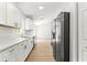 Modern kitchen features stainless steel appliances, white cabinets and granite countertops at 14876 Se 34Th Ter, Summerfield, FL 34491