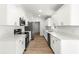 Modern kitchen with white cabinets, stainless steel appliances, and quartz countertops at 14876 Se 34Th Ter, Summerfield, FL 34491
