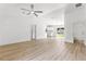 Bright and modern living room with a ceiling fan and access to other rooms at 14876 Se 34Th Ter, Summerfield, FL 34491