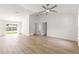 Bright and airy living room with hardwood floors and a sliding glass door to the outside at 14876 Se 34Th Ter, Summerfield, FL 34491