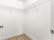 Walk-in closet featuring wire shelving and hardwood floors at 14876 Se 34Th Ter, Summerfield, FL 34491