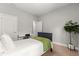 Cozy bedroom with a comfortable bed, carpet flooring and a large indoor plant at 155 Marion Oaks Pass, Ocala, FL 34473