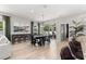 Dining area with a modern black dining table, leading to the outdoor patio through glass sliding doors at 155 Marion Oaks Pass, Ocala, FL 34473