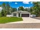 Charming home with a manicured front lawn, a two-car garage, and tasteful landscaping at 155 Marion Oaks Pass, Ocala, FL 34473