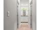 Hallway view to stylish bathroom featuring neutral colors, granite counters and modern accents at 155 Marion Oaks Pass, Ocala, FL 34473