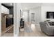 Bright hallway featuring wood-look flooring, white trim and doors, and access to the laundry room and living area at 155 Marion Oaks Pass, Ocala, FL 34473
