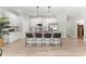 Bright kitchen featuring stainless steel appliances, granite countertops, and a large island with bar stool seating at 155 Marion Oaks Pass, Ocala, FL 34473