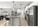 Bright open-concept kitchen featuring stainless steel appliances, granite countertops, and a large island with seating at 155 Marion Oaks Pass, Ocala, FL 34473