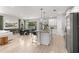 Bright open-concept kitchen featuring stainless steel appliances, granite countertops, and a large island with seating at 155 Marion Oaks Pass, Ocala, FL 34473