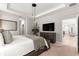 Stylish main bedroom featuring sleek lighting, a media center, and comfortable decor at 155 Marion Oaks Pass, Ocala, FL 34473