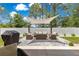 Relaxing outdoor patio area with a sun shade, a grill and comfortable seating at 155 Marion Oaks Pass, Ocala, FL 34473