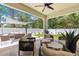 Comfortable and covered outdoor patio area with modern furniture and a ceiling fan at 155 Marion Oaks Pass, Ocala, FL 34473