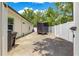 Gated side yard with gravel surface ideal for parking at 155 Marion Oaks Pass, Ocala, FL 34473