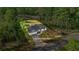 An aerial view of a charming home with a paved driveway, nestled amongst trees at 158 Guava Pass, Ocklawaha, FL 32179