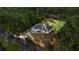 An aerial shot of the home showcases its secluded location and surrounding lush greenery at 158 Guava Pass, Ocklawaha, FL 32179