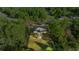 Aerial view of a single-story home surrounded by lush trees at 158 Guava Pass, Ocklawaha, FL 32179