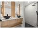 Modern bathroom featuring dual vanities, stylish mirrors and walk-in shower at 158 Guava Pass, Ocklawaha, FL 32179
