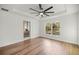 Bright bedroom with hardwood floors, a ceiling fan, and access to an ensuite bathroom at 158 Guava Pass, Ocklawaha, FL 32179