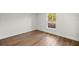 Bright bedroom with wood-look flooring and window view to the outdoors at 158 Guava Pass, Ocklawaha, FL 32179