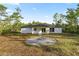 Charming single-story home with a neutral color palette and manicured lawn at 158 Guava Pass, Ocklawaha, FL 32179