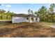 Angle view of a modern single-story home with a well-kept lawn at 158 Guava Pass, Ocklawaha, FL 32179
