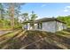 Side view of a modern single-story home with a well-kept lawn at 158 Guava Pass, Ocklawaha, FL 32179