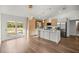 Modern kitchen featuring a large island, stainless steel appliances, and sleek finishes at 158 Guava Pass, Ocklawaha, FL 32179