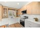 Modern kitchen featuring wood cabinets, white countertops, and stainless steel appliances at 158 Guava Pass, Ocklawaha, FL 32179