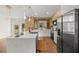 Open kitchen with large island, stainless steel appliances, and backyard view at 158 Guava Pass, Ocklawaha, FL 32179