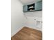 Convenient laundry room with overhead cabinets and utility connections at 158 Guava Pass, Ocklawaha, FL 32179