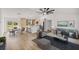 Open-concept living area with modern furnishings and a stylish kitchen featuring a large island at 158 Guava Pass, Ocklawaha, FL 32179