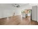 Spacious open-concept living area with wood floors, modern ceiling fan, and ample natural light at 158 Guava Pass, Ocklawaha, FL 32179