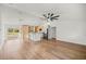 Bright open-concept area with sleek kitchen island and modern lighting fixtures at 158 Guava Pass, Ocklawaha, FL 32179