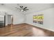 Bright open-concept living area featuring wood floors, large windows, and contemporary finishes at 158 Guava Pass, Ocklawaha, FL 32179