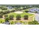 Community ball field, pool and recreational vehicle parking surrounded by mature trees and lush green grass at 16023 Sw 14Th Avenue Rd, Ocala, FL 34473