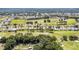 Expansive aerial view of a residential community with manicured lawns, tree-lined streets, and golf course access at 16023 Sw 14Th Avenue Rd, Ocala, FL 34473