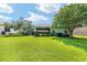 Lush green backyard with mature trees and a screened lanai, perfect for outdoor enjoyment at 16023 Sw 14Th Avenue Rd, Ocala, FL 34473