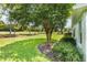 Picturesque backyard with a mature tree, lush greenery, and serene views of the golf course at 16023 Sw 14Th Avenue Rd, Ocala, FL 34473