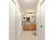 Hallway view of bright bathroom with double sink and tile floors at 16023 Sw 14Th Avenue Rd, Ocala, FL 34473