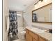 Bathroom featuring a vanity, mirror, shower and toilet at 16023 Sw 14Th Avenue Rd, Ocala, FL 34473